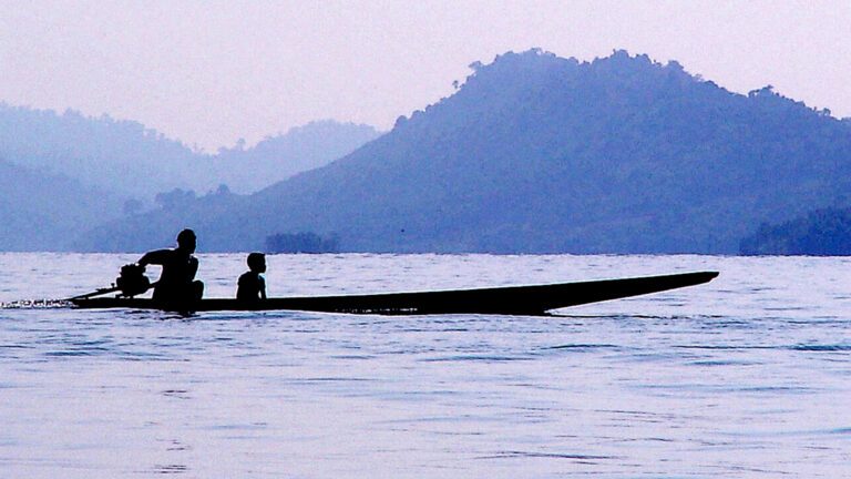 Canoe Silhouette on Misty Water