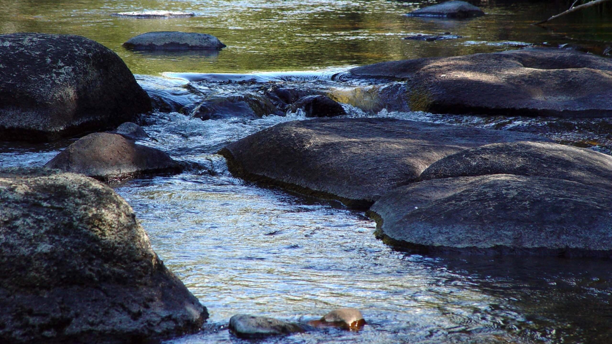 Rocky Stream with Flowing Water 4K Wallpaper