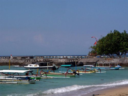 Traditional fishing boats floating near the harbor in Sanur Bali