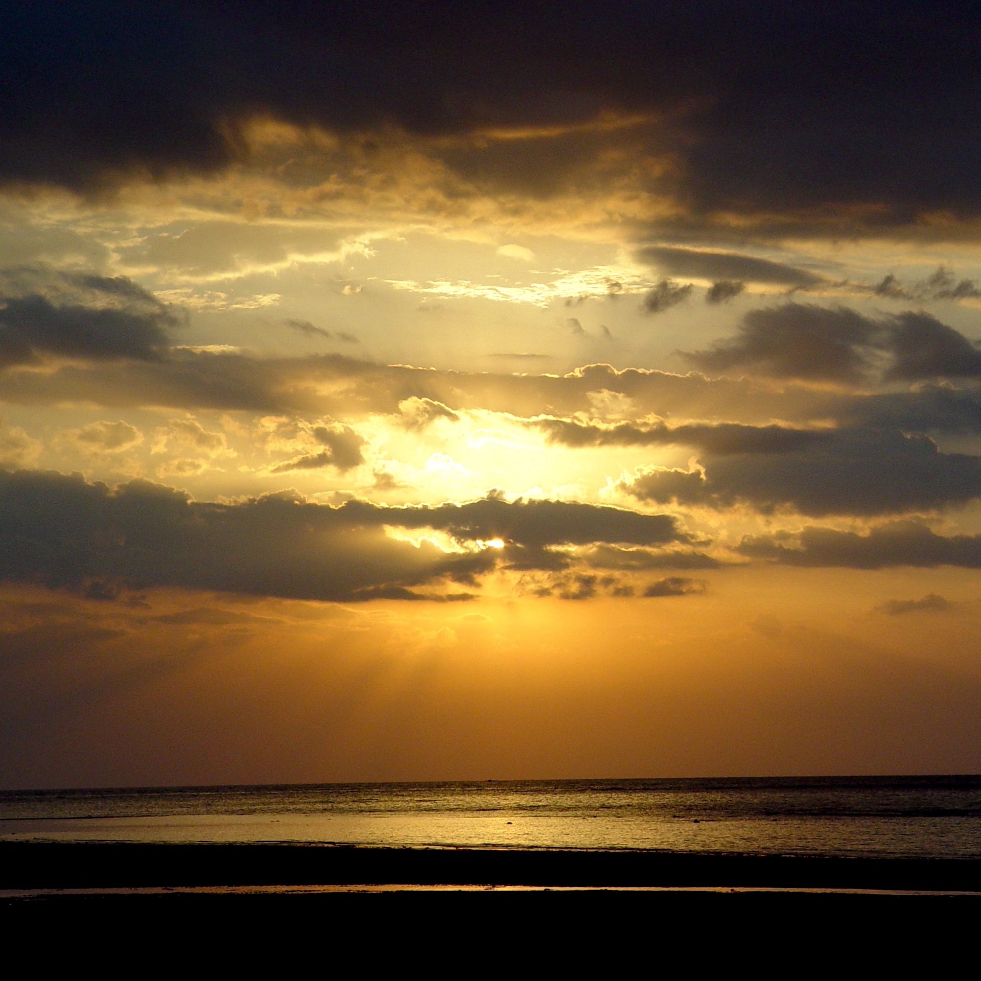 Golden Ocean Sunset with Dramatic Clouds