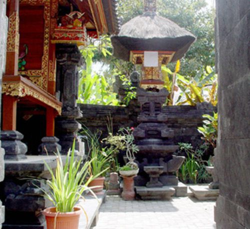 Traditional Balinese courtyard with shrine and tropical plants in Sanur Bali