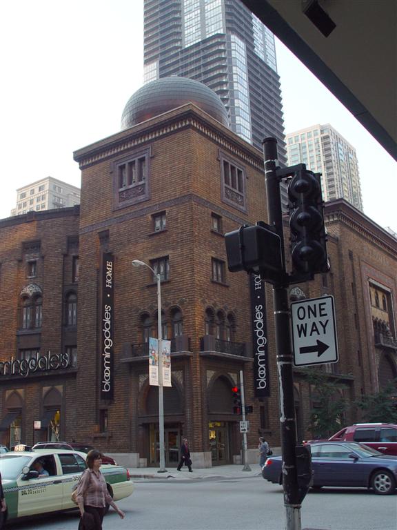Historic brick building surrounded by modern skyscrapers in downtown Chicago.