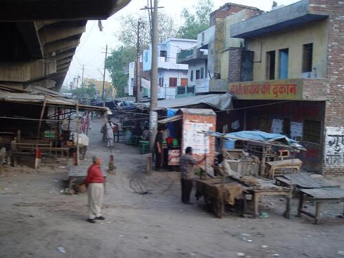 Small market street and shops located beside a railway line in northern India.