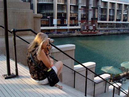 Judy taking photographs along the Chicago River during a sightseeing trip.