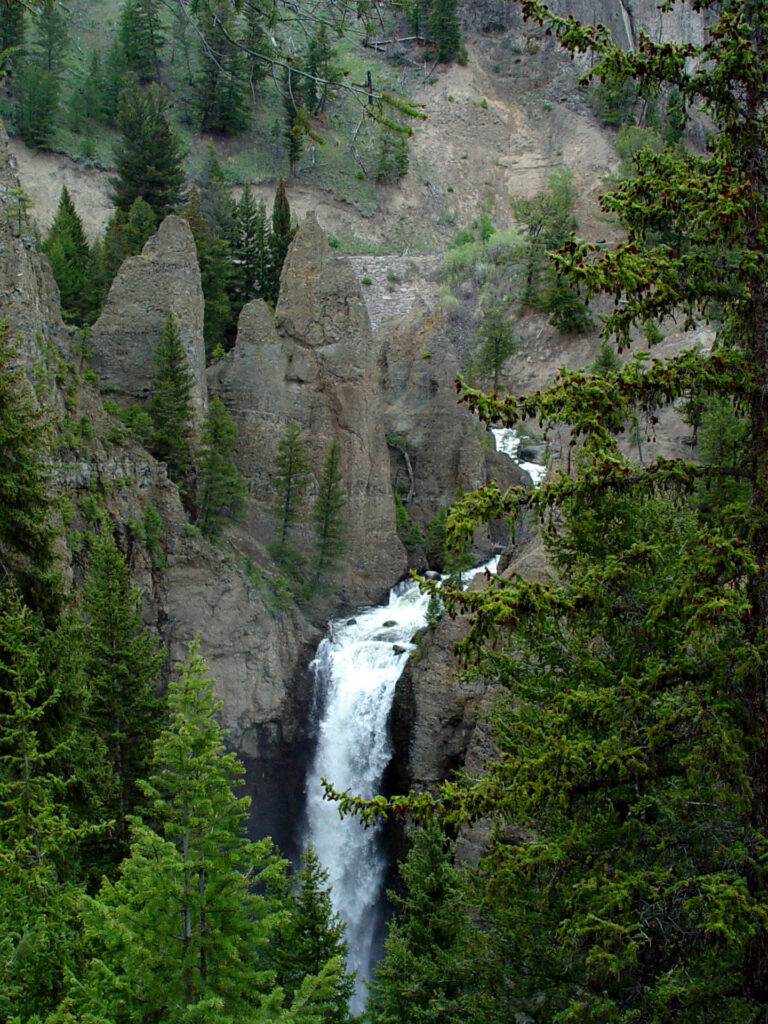 Tower Fall cascading through dramatic rock spires in Yellowstone National Park.